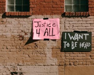 social justice handwritten signs on old building