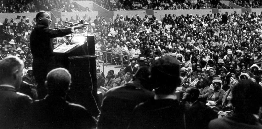 martin luther king making a speech at podium