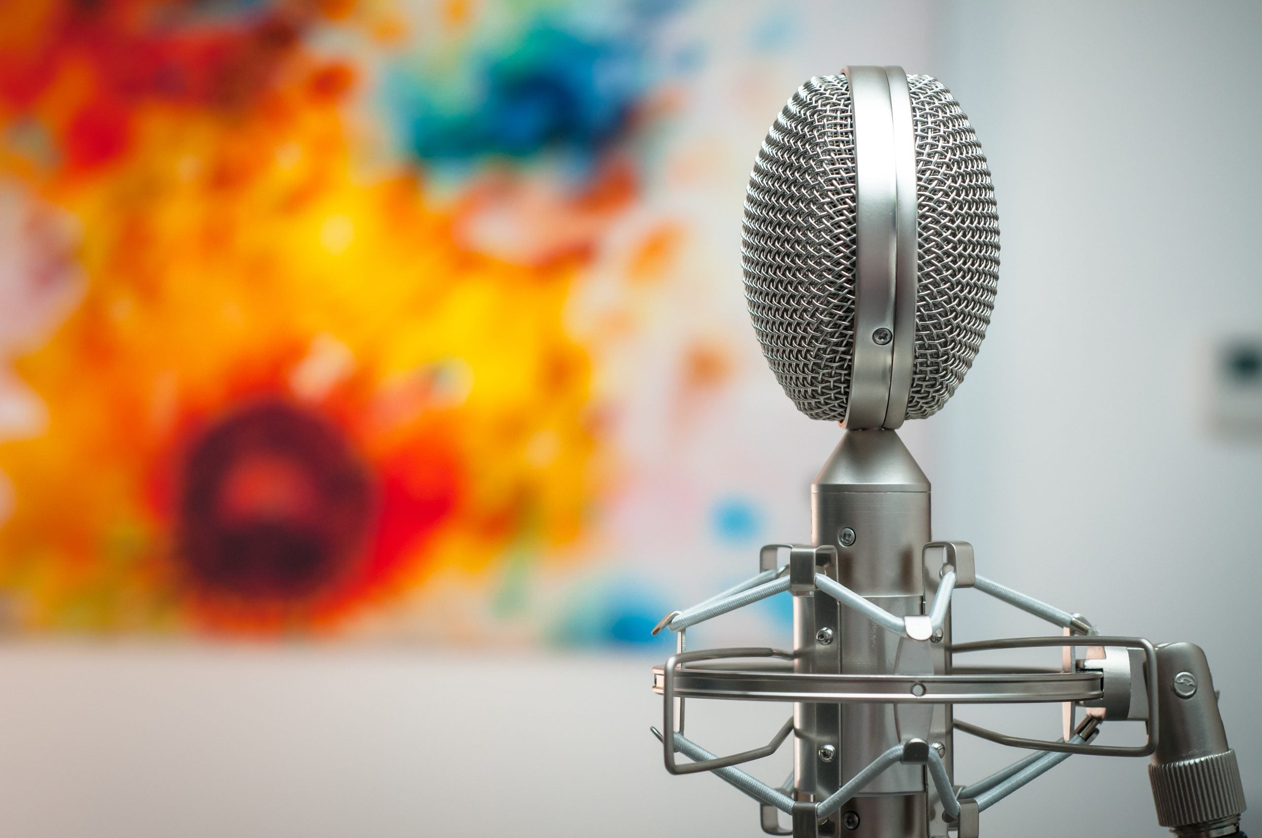 microphone in front of a colorfully-painted wall