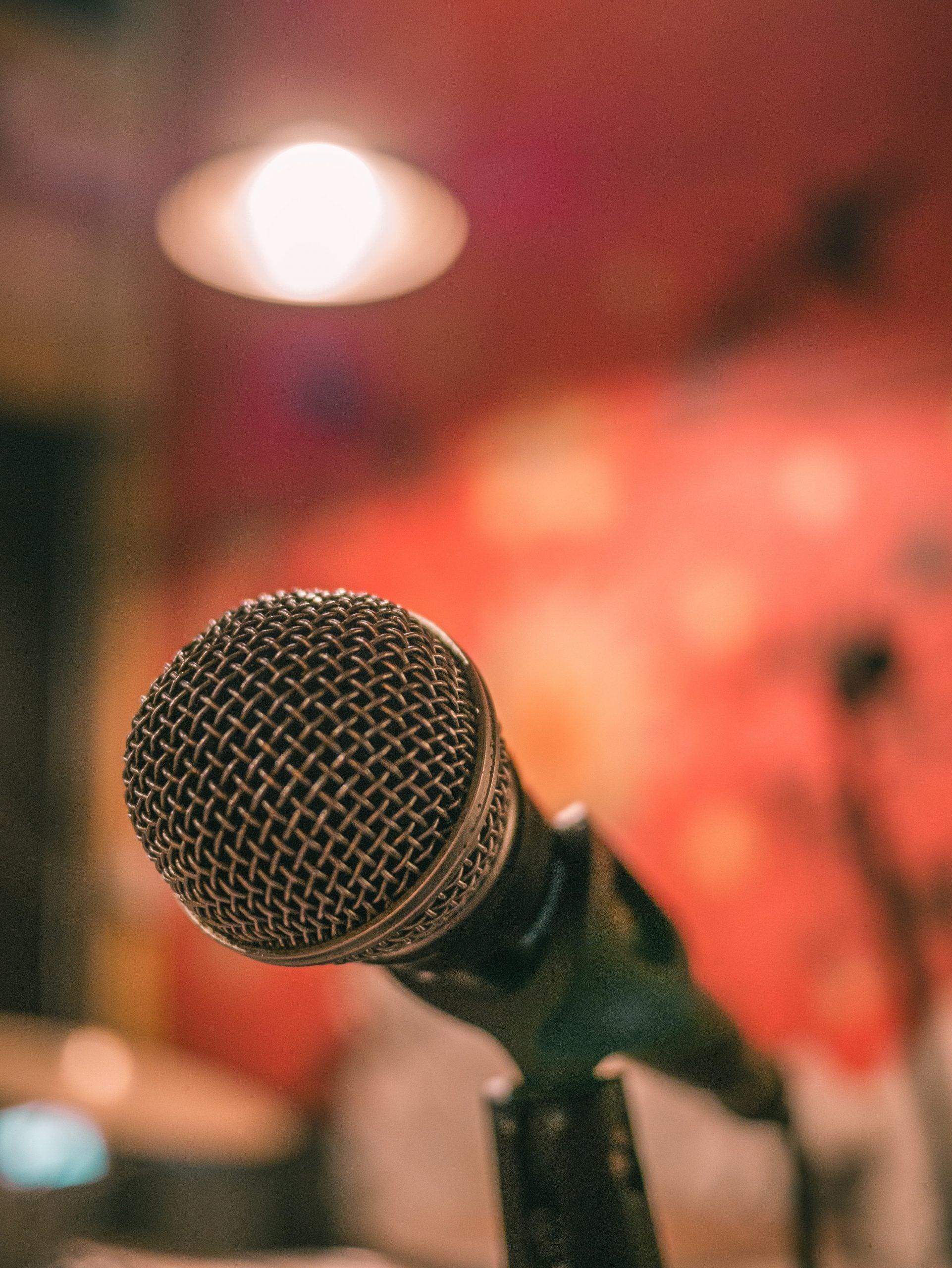 a microphone against a red wallpaper background
