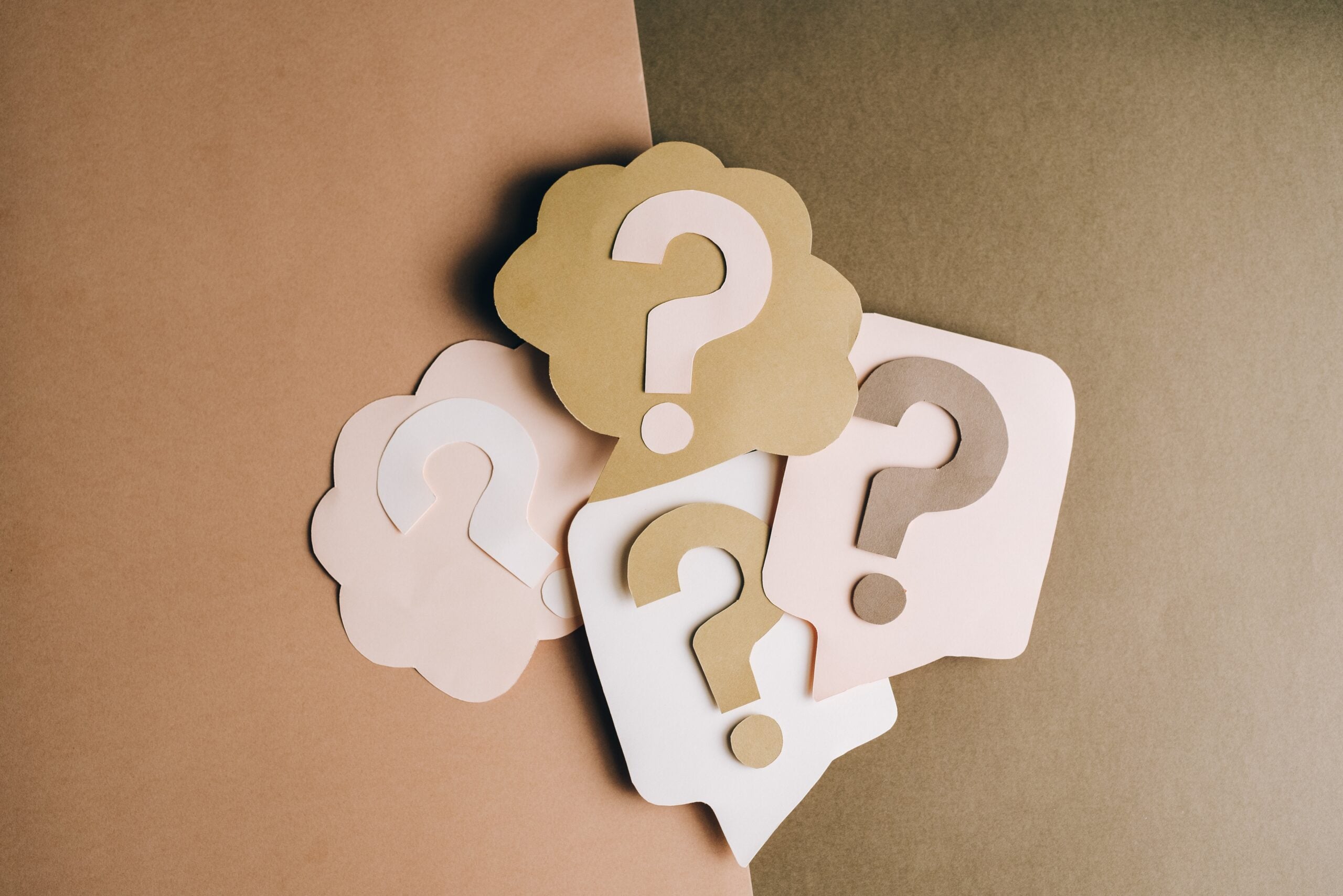 carboard, colorful cutouts of multiple question marks