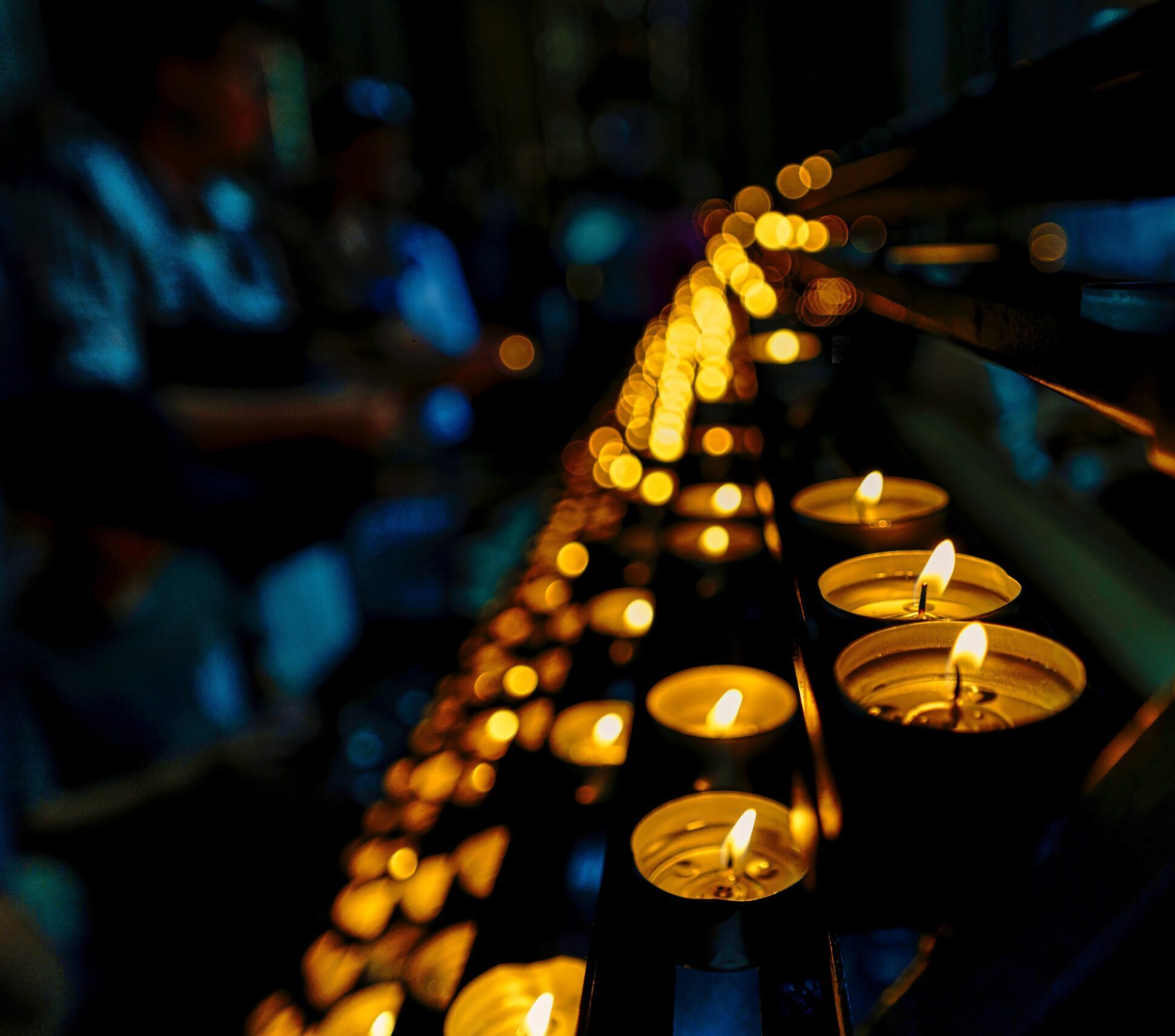 row of vigil candles at night