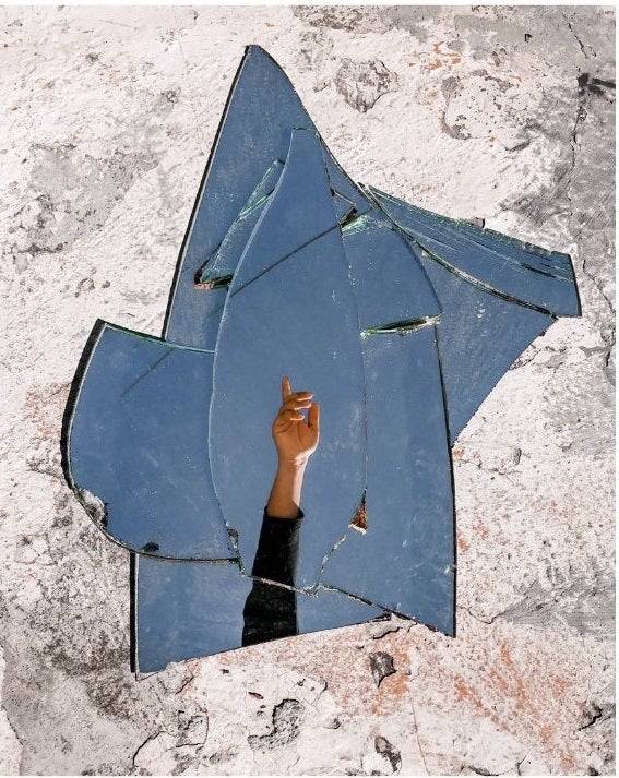 a broken missis on the ground showing a single hand