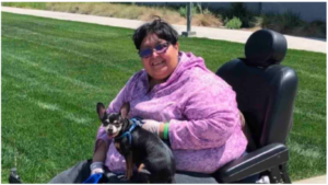 laura mendoza in a wheelchair with a dog